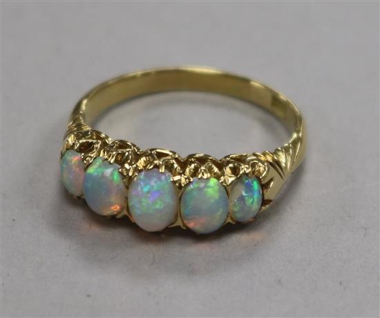An 18ct gold and graduated five stone white opal half hoop ring, size N.